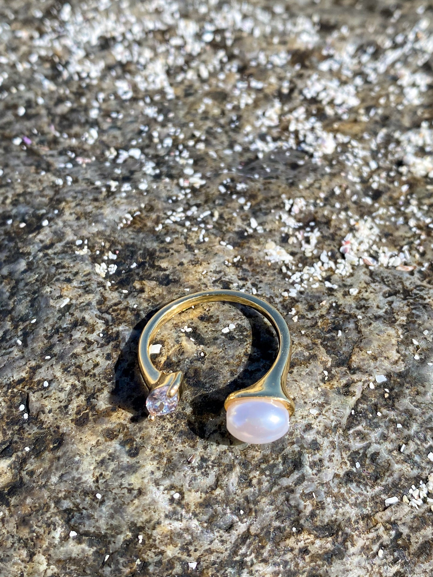 Anillo dorado con perla y circón ovalado